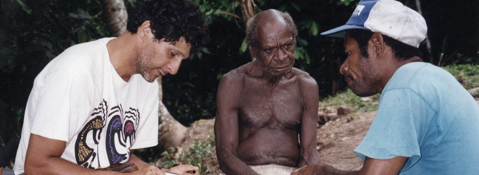 Dr. Saine with Philip, his interpreter, taking notes from a village healer (center) in 1998 deep in the jungle of Papua New Guinea.